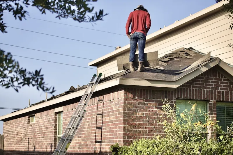 Professional roofer working on a residential roof in Cocoplum